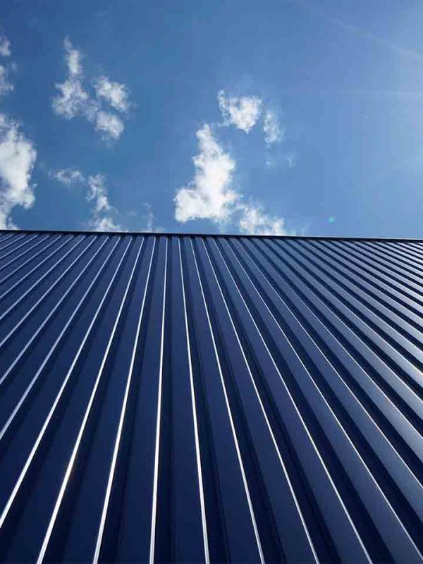 A low angle shot of a metal roof of a building on a sunny day